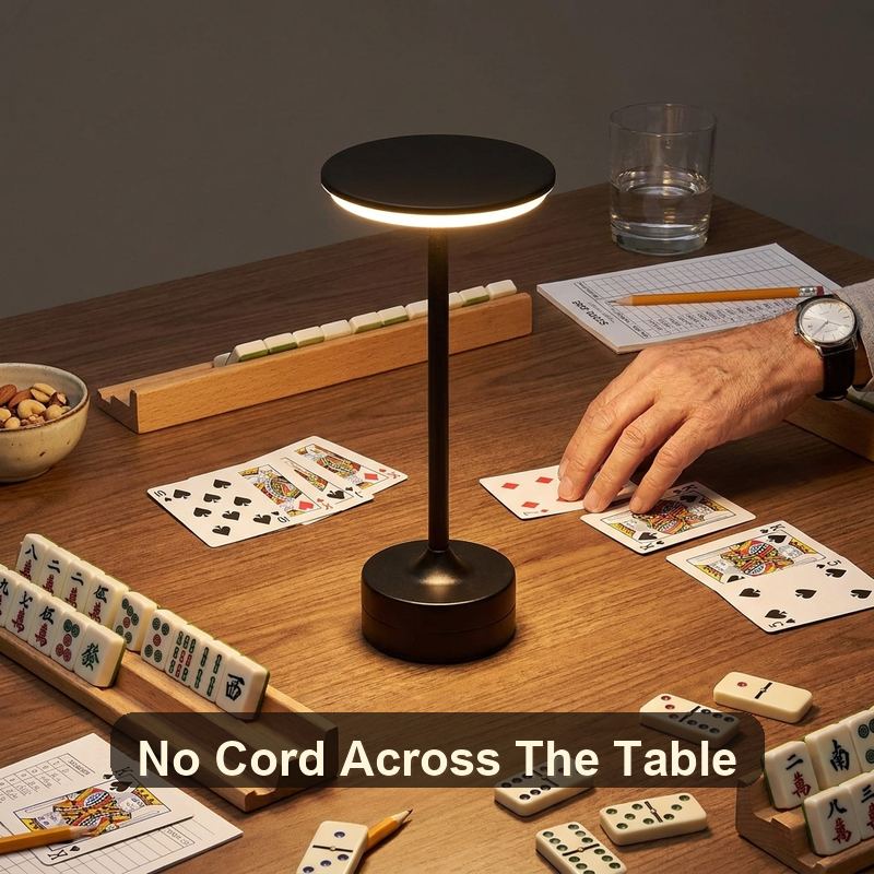 Black EMBAR lamp with compact base leaving room for cards tiles snacks drinks and score pads
